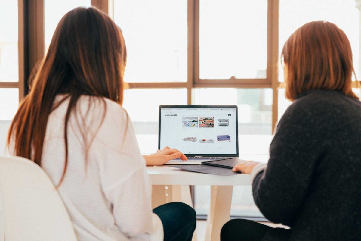 two women looking at laptop screen